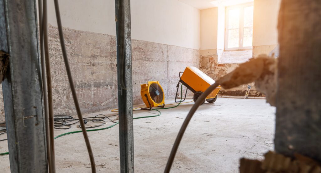 Removing water and humidity from an apartment using industrial fans and equipment after water damage